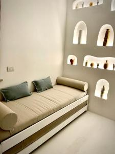 a couch in a room with arches on the wall at Sole Suites in Sorrento