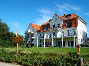 a large white building with an orange roof at Schöner Blick in Am Schwarzen Busch