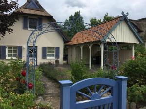 a blue gate in front of a house at Möwennest in Am Schwarzen Busch
