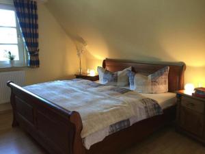 a bedroom with a large bed with pillows on it at Möwennest in Am Schwarzen Busch