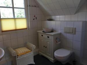 a bathroom with a toilet and a sink at Möwennest in Am Schwarzen Busch