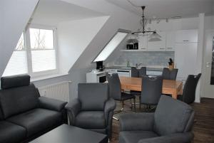 a living room with a table and chairs and a kitchen at Seesternchen in Am Schwarzen Busch