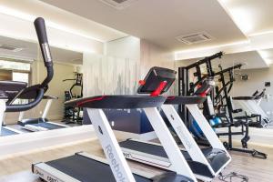 a gym with several tread machines in a room at Vossa Bossa Vila Madalena in Sao Paulo