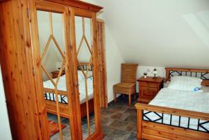a bedroom with a wooden bunk bed and a desk at "Utkiek" im "Roden Hus" in Timmendorf