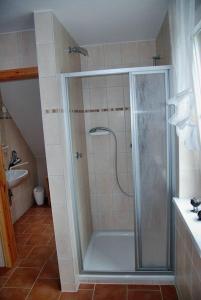 a shower with a glass door in a bathroom at "Utkiek" im "Roden Hus" in Timmendorf +13 photos