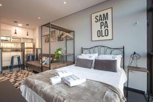 a bedroom with a large bed with two towels on it at Vossa Bossa Copan in São Paulo