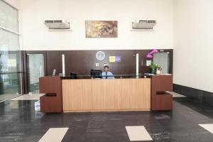 a person sitting at a desk in an office at Vossa Bossa Bela Cintra in Sao Paulo +133 photos