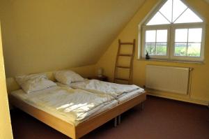 a bed in a room with a large window at Andrea in Timmendorf