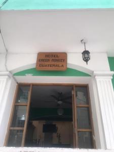 a sign on the front of a building at Green Monkey Hostel in Flores