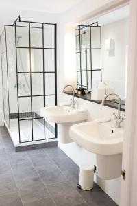 a bathroom with two sinks and a shower at The Olde Bell, BW Signature Collection in Marlow
