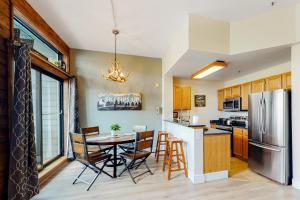 a kitchen with a table and chairs and a refrigerator at Blue River Escapade in Breckenridge