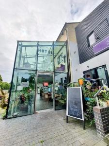 un edificio de cristal con un cartel delante en The Old Mill Thai vintage, en Whitchurch