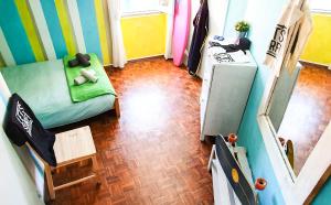 an overhead view of a living room with a green couch at Ericeira Surf Camp in Ericeira +101 photos