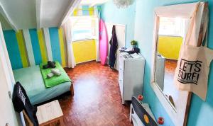 a small room with a bed and a desk in it at Ericeira Surf Camp in Ericeira