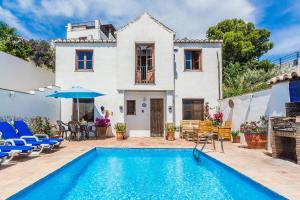 a villa with a swimming pool in front of a house at Casas Mundo Sol y Luna - 3 houses with pool, wifi & AC - Andalusia in Pinos del Valle