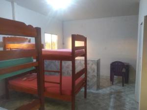 a bedroom with two bunk beds in a room at Hostel Viajante Marajo in Soure