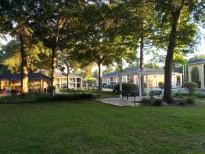 a park with a bench and trees and a building at SureStay Plus Hotel by Best Western St Marys Cumberland in Saint Marys