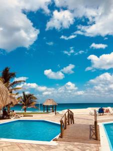 a swimming pool with a view of the beach at Brisas Apartment ZH in Cancún
