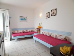 a living room with two beds and a table at Malia Star Apartments in Malia +69 photos