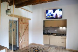 a kitchen with a flat screen tv on the wall at Sete Cidades Nature Villa in Sete Cidades