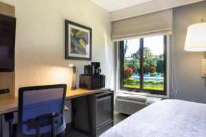 a hotel room with a bed and a desk and a window at Holiday Inn Express San Jose Costa Rica Airport by IHG in Alajuela City