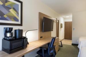 a hotel room with a desk and a tv at Holiday Inn Express San Jose Costa Rica Airport by IHG in Alajuela City