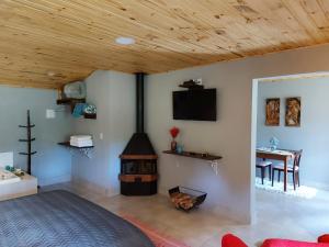a bedroom with a woodburning stove in a room at Pousada Polessas in Visconde De Maua