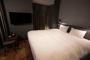 Postel nebo postele na pokoji v ubytování LOF HOTEL Shimbashi