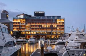 a marriott hotel with boats docked in a marina at Park Hyatt Auckland in Auckland