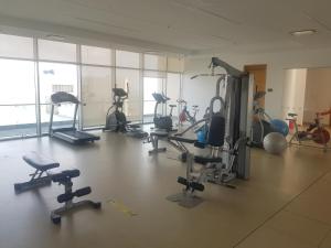 a gym with several treadmills and exercise bikes at H2 Hyatt Vista Mar!! in Cartagena de Indias