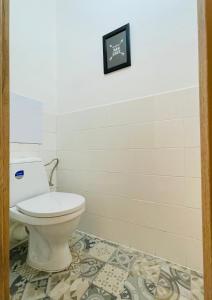 a bathroom with a toilet and a tile floor at ZAROHEM 2 bedrooms APARTMENT in center with balcony in Brno