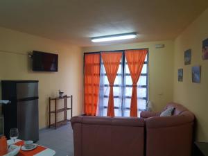 a living room with a couch in front of a window at Apartamento MiraMar in Garachico