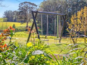a swing set in the middle of a garden at Protestant Hall in Wildes Meadow +16 photos