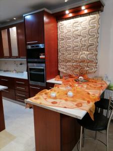 a kitchen with a counter with a table in it at MARIALENAS HOUSE in Archangelos +5 photos