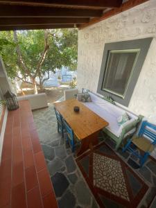 a room with a wooden table and chairs and a table at Patmos Villas in Grikos
