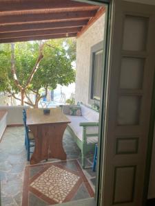 a door to a patio with a table and a couch at Patmos Villas in Grikos