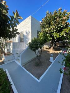 a white house with trees in front of it at Patmos Villas in Grikos