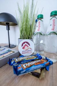 a table with some chips and a bottle of water at Apartamenty Pawełek in Zator