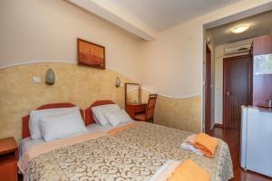 a bedroom with a large bed in a room at Apartments Pod Lozom with Seaview in Petrovac na Moru