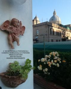 a book with a picture of a garden with a statue at La Corte degli Angeli Locazioni Turistiche in Assisi