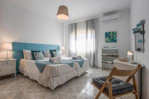 a bedroom with a large bed with a blue headboard at Villa Casa Rosina in Ferragudo +17 photos