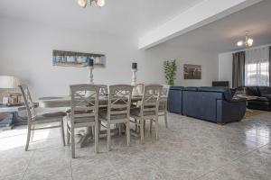 comedor y sala de estar con mesa y sillas en Villa Casa Rosina, en Ferragudo