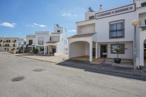 an empty street with white buildings on the side at Villa Casa Rosina in Ferragudo