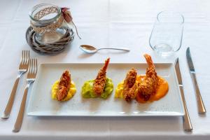 a white plate with fried food on a table at Draconerium Hotel in Dronero