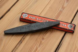 a knife sitting on top of a wooden table at Draconerium Hotel in Dronero