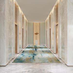 an empty hallway with a door and a rug on the floor at Holiday Inn Resort Ho Tram Beach by IHG in Ho Tram