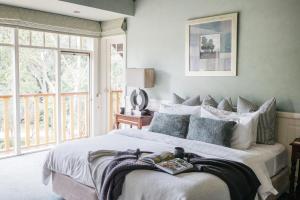 a bedroom with a large bed and a window at Lawson Lodge Country Estate in Macedon