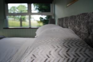 a close up of a bed in a room with a window at Mountainview in Ballyward