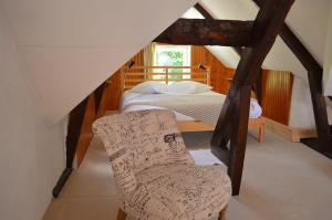 A bed or beds in a room at Lodge Kervoazec - Château de Kervoazec