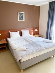 Una cama o camas en una habitación de Ośrodek Wypoczynkowo-Rehabilitacyjny Perła Borów